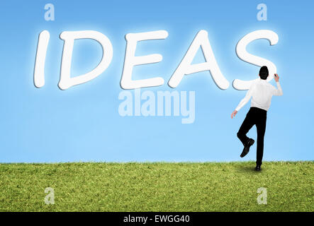 Business man writing on sky Ideas word Stock Photo