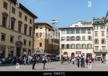 Florence, Italy the Piazza della Signoras it would have been, people crowd the street while typically Italian urban architecture Stock Photo