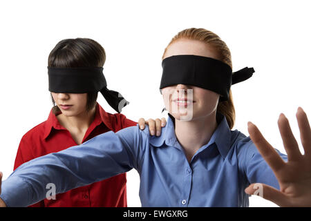 two business woman blind folded leading the other Stock Photo