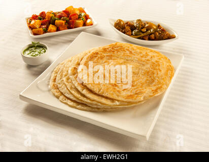 Paratha served with green chutney mixed vegetable and pickles Stock Photo