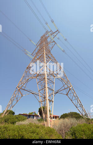 High voltage pylon over houses Stock Photo