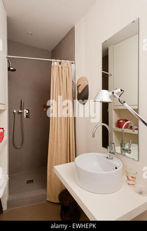 Modern bathroom with shower and Artemide lamp Stock Photo