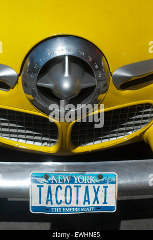 1950 Studebaker yellow taxi outside the Caliente Cab Mexican restaurant on Seventh Avenue, Greenwich Village, New York City, USA. Stock Photo