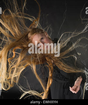 Blond Woman with Wind Blowing Through Long Hair Stock Photo