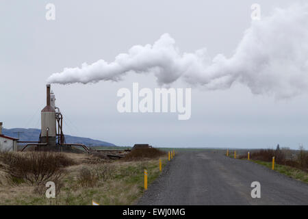 small rural community geothermal energy plant steam blowing over rural gravel road southern iceland Stock Photo
