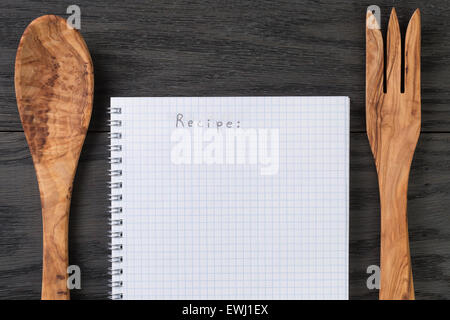 notepad with word recipe on wood table with utensils Stock Photo