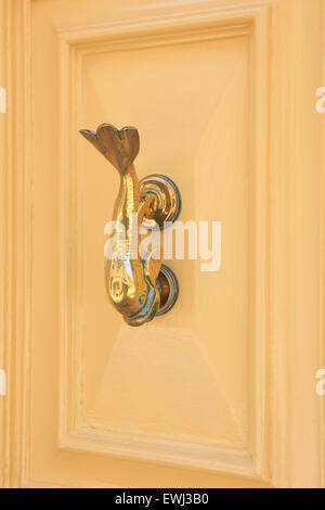 Traditional dolphin-shaped Maltese door knocker in Mosta, Malta Stock Photo