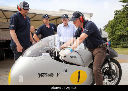 Goodwood, West Sussex, UK. 26th June, 2015. John Surtees, OBE, British former Grand Prix motorcycle road racer and Formula One driver pictured obseriving a Norton motorcycle. The Goodwood Festival of Speed is an annual hill climb featuring historic motor racing vehicles held in the grounds of Goodwood House, West Sussex. Credit:  Oliver Dixon/Alamy Live News Stock Photo