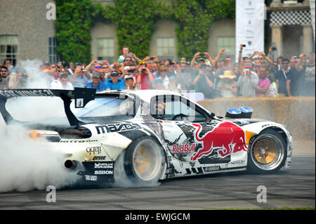 Goodwood, Chichester, UK. 26th June 2015 Cars spin their wheel and smoke their tryes at the Goodwood Festival of Speed. The major automotive event attracts thousands of people to the Goodwood House in Sussex where hundreds of modern and historic cars participate in a hill climb. Credit:  Jonny White/Alamy Live News Stock Photo