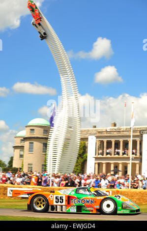 Goodwood, Chichester, UK. 26th June 2015 A Mazda passes the Mazda sculpture at the Goodwood Festival of Speed. The major automotive event attracts thousands of people to the Goodwood House in Sussex where hundreds of modern and historic cars participate in a hill climb. Credit:  Jonny White/Alamy Live News Stock Photo