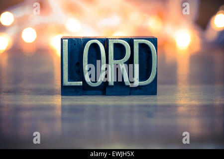 The word LORD written in vintage metal letterpress type on a soft backlit background. Stock Photo