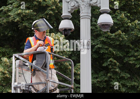 Technician installing outdoor security camera system - USA Stock Photo