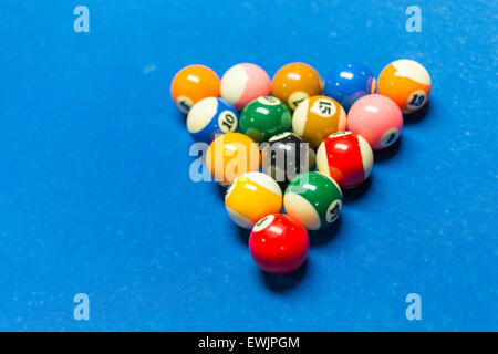 Balls racked on on a pool table with blue felt Stock Photo