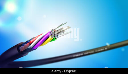 Stripped fiber optic cable over blue background with spot lights, communication network technology. Stock Photo