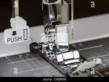 Presser foot. Closeup of the presser foot and needle of an electric sewing machine. Stock Photo