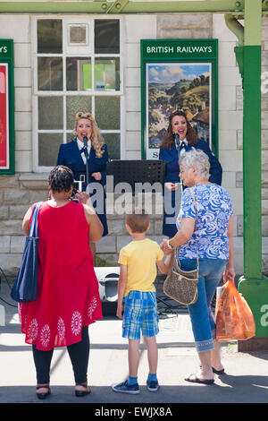 Swanage, Dorset, UK. 27th June, 2015. Purbeck At War and Armed Forces Weekend at Swanage Railway Train station - the (fabulous) Mellor Sisters, 40s Retro Style Duette Singers, entertain the crowds with songs from the past Credit:  Carolyn Jenkins/Ģ����ý Live News Stock Photo