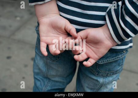 boys hands behind back Stock Photo