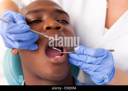 African male patient getting dental treatment in hospital Stock Photo