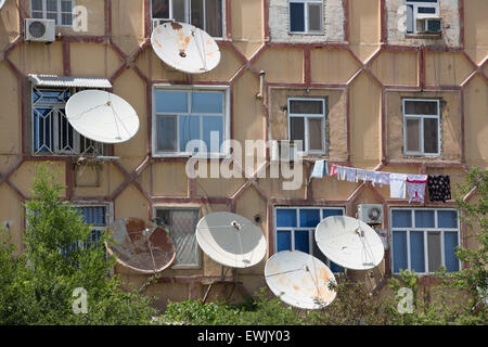 Satellite dishes on Soviet-era apartment block in Mary, Turkmenistan Stock Photo