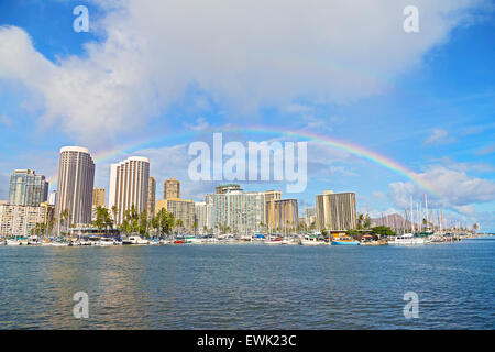 Rainbow over Waikiki beach resort and marina in Honolulu, Hawaii, USA.