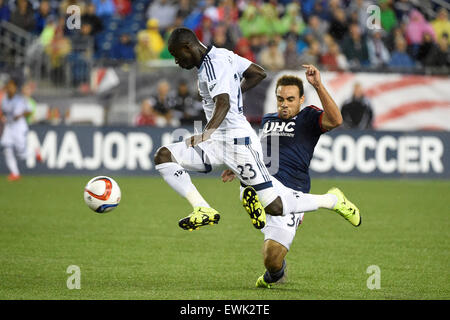 Foxborough, Massachusetts, USA. 27th June, 2015. Vancouver FC forward Kekuta Manneh (23) trips over New England Revolution defender Kevin Alston (30) while playing the ball during the MLS game between Vancouver Whitecaps and the New England Revolution held at Gillette Stadium in Foxborough Massachusetts. Vancouver defeated New England 2-1. Eric Canha/CSM/Alamy Live News Stock Photo