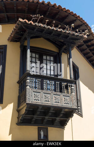 LA OROTAVA, TENERIFE, SPAIN - JUNE 23, 2015: old house (now a clothing store) with traditional carved wooden balcony in the hist Stock Photo