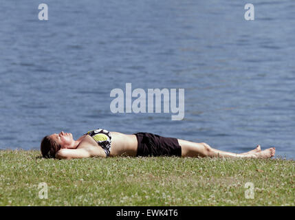 Vancouver, Canada. 27th June, 2015. A resident enjoys sun tanning at a park in Vancouver, Canada, June 27, 2015. According to the weather forecast from Environment Canada, heat wave warning was issued in Vancouver with temperature expected to rise dramatically over the weekend with about 30 degree Celsius. The inland of British Columbia may hit at 40 degree. © Liang sen/Xinhua/Alamy Live News Stock Photo