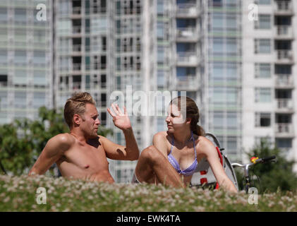Vancouver, Canada. 27th June, 2015. Residents enjoy sun tanning at a park in Vancouver, Canada, June 27, 2015. According to the weather forecast from Environment Canada, heat wave warning was issued in Vancouver with temperature expected to rise dramatically over the weekend with about 30 degree Celsius. The inland of British Columbia may hit at 40 degree. © Liang sen/Xinhua/Alamy Live News Stock Photo