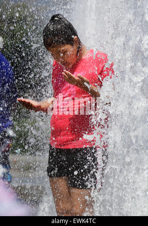 Vancouver, Canada. 27th June, 2015. A girl cools herself at a fountain inside a park in Vancouver, Canada, June 27, 2015. According to the weather forecast from Environment Canada, heat wave warning was issued in Vancouver with temperature expected to rise dramatically over the weekend with about 30 degree Celsius. The inland of British Columbia may hit at 40 degree. © Liang sen/Xinhua/Alamy Live News Stock Photo