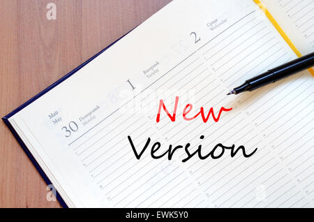 Yellow blank notepad on office wooden table and text concept Stock Photo
