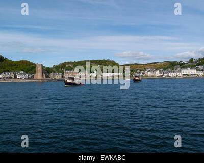 View historic sea front of popular resort town Oban Argyll and Bute Scotland from ferry on Sound of Kerrera on a lovely May day weather blue sky Stock Photo