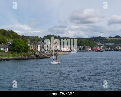 Oban Argyll and Bute Scotland viewed from approaching ferry through Sound of Kerrera a popular resort town on lovely May day weather blue sky Stock Photo