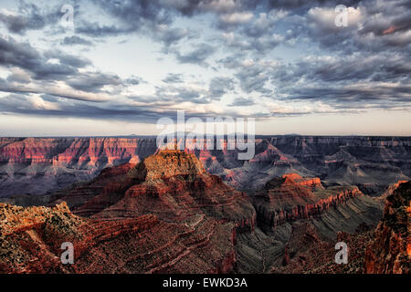 Last light on the North Rim of Arizona’s Grand Canyon National Park from Cape Royal with a distant snow capped Humphreys Peak. Stock Photo