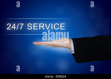 24 hours a day, 7 days a week service button with business hand on blue background Stock Photo