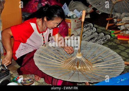 Chiang Mai, Thailand: Thai woman making a paper parasol at the Sa Paper & Umbrella Handicraft Centre at Borsang Village Stock Photo