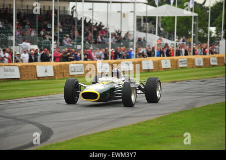 Damon Hill in a Lotus 49 driven by his father at the Goodwood Festival of Speed. Racing drivers, celebrities and thousands of members of the public attended the Goodwood Festival of Speed to see modern and old racing cars and bikes in action. Stock Photo