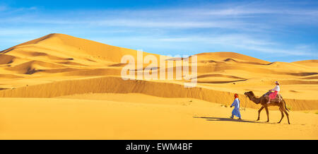 Tourist on camel ride, Erg Chebbi desert near Merzouga, Sahara, Morocco Stock Photo