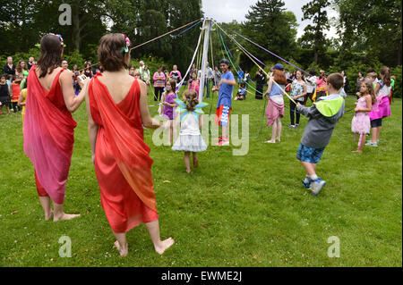 June 28, 2015 - Old Westbury, New York, United States - Lori Belilove & The Isadora Duncan Dance Company, wearing colorful Renaissance themed tunics, give Maypole Dance lessons to children on the South Allee of historic Old Westbury Gardens, a Long Island Gold Coast estate, for its Midsummer Night event. (Credit Image: © Ann Parry/ZUMA Wire) Stock Photo