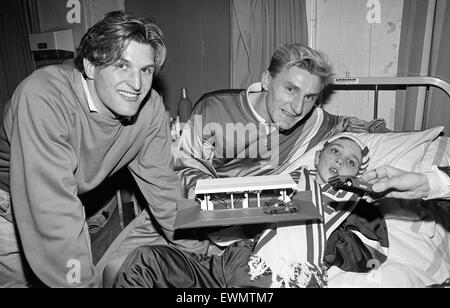 Middlesbrough footballers, Tony Mowbray (right), hand out presents to children at Middlesbrough General Hospital. December 1988.