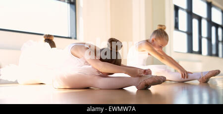 Young girls doing fitness exercises in the gym. Training in the