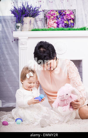 Child and grandmother with Easter eggs Stock Photo