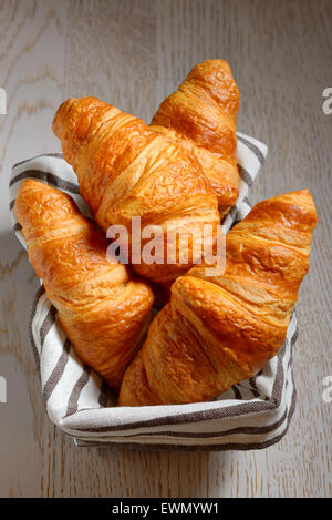 croissants in a basket on table Stock Photo
