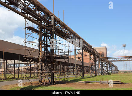 Scaffolding surrounds pipe gantries and conveyor belt housings at the re-opened Redcar Steelworks, Cleveland, UK