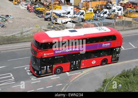 High level view of one of London's new Routmaster double-deck buses. Shown passing a contractors yard on Lea Bridge Road. Stock Photo