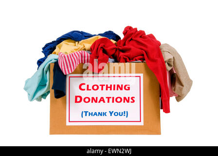 Donation box full of clothes shot in studio isolated on white background. Stock Photo