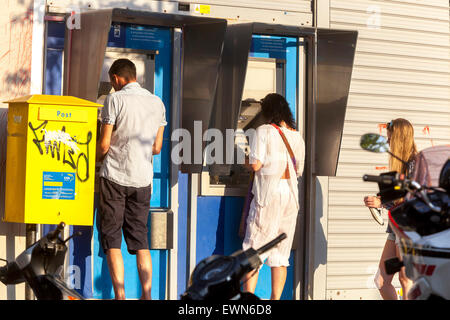 Crete, Greece. 28th June, 2015. People withdraw money  from ATMs, Rethymno, Crete, Greece bank Stock Photo