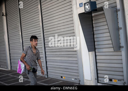 A man walks in front of a closed bank in Athens, Greece on the 29th of June 2015. Photo: Socrates Baltagiannis/dpa Stock Photo