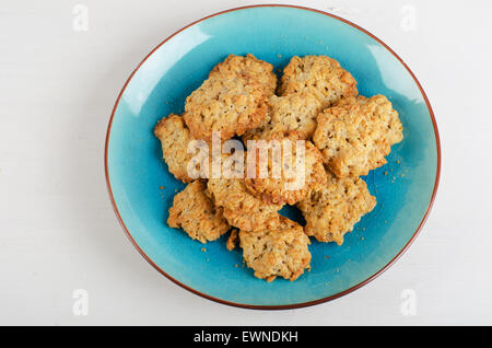 Freshly baked oatmeal cookies in a blue plate. Top view Stock Photo