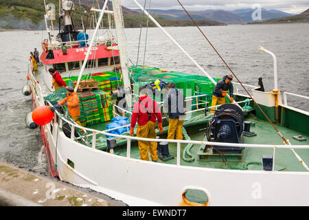 A fishing trawler putting to sea from Ullapool, Scotland, UK. Stock Photo