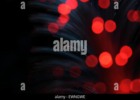 Red glowing transparent optical fibers. Stock Photo